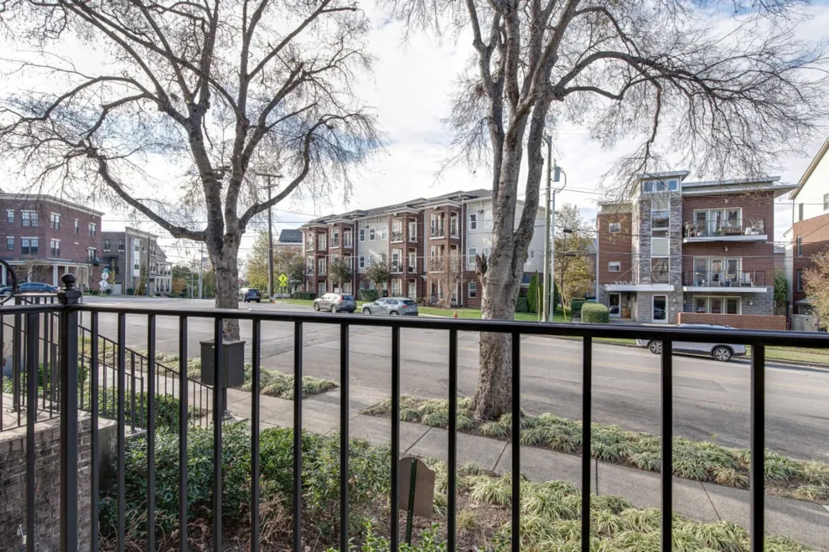 A relaxed tree-lined street view with glimpses of surrounding buildings. People are depicted walking, jogging, and socializing, reinforcing a sense of community and urban exploration in the area.